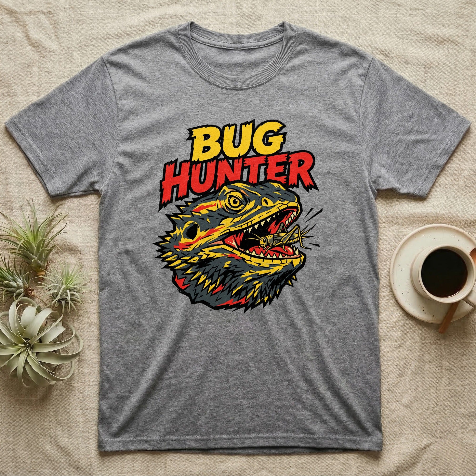Grey t-shirt featuring a stylized, aggressive bearded dragon eating an insect.