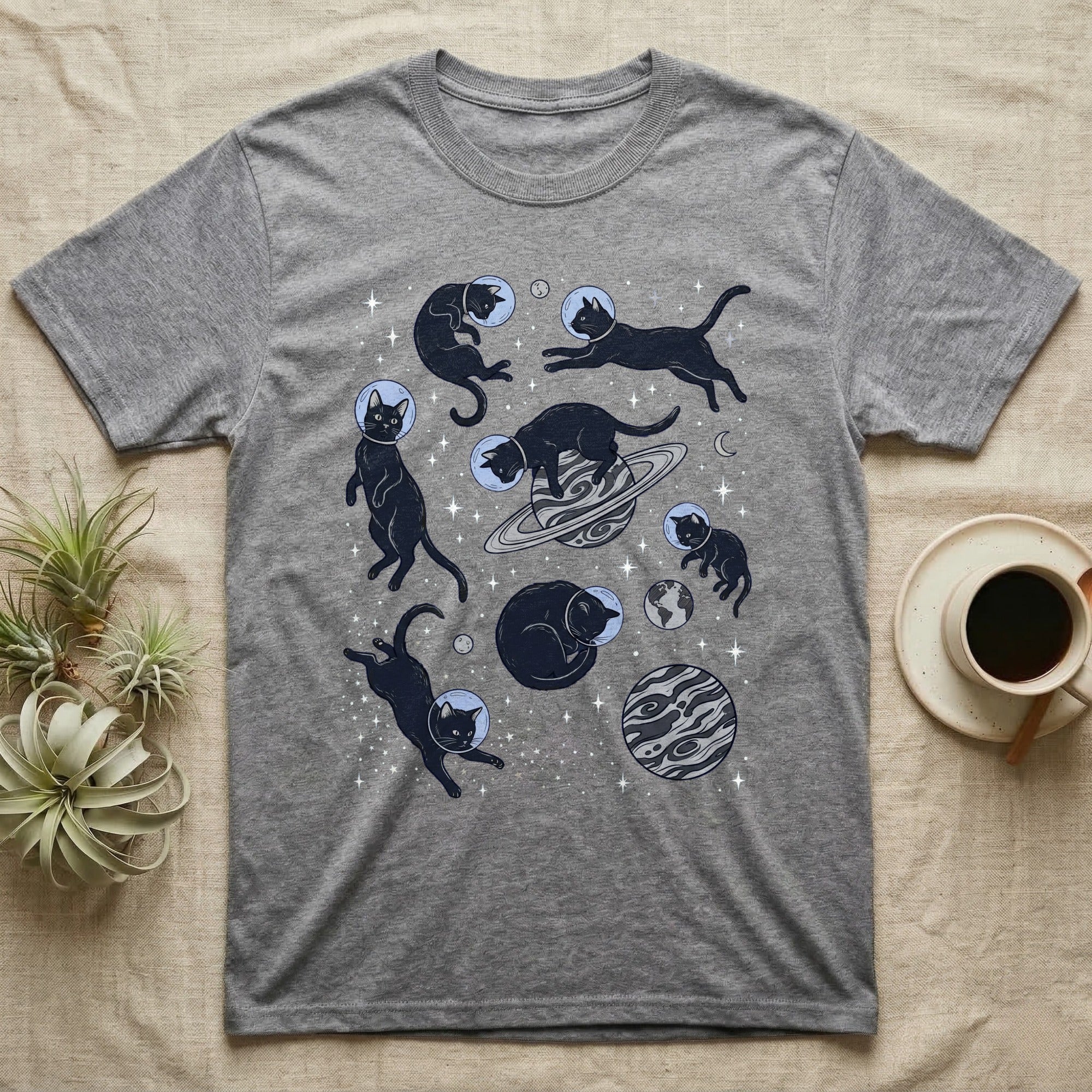 Gray t-shirt with black cats floating in space with planets and stars.