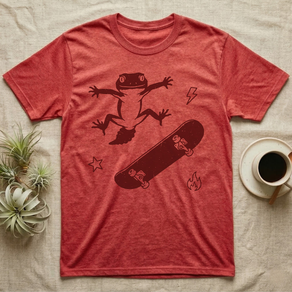 Knob-Tailed Gecko Kickflip T-Shirt in Heather Red — Distressed one-ink illustration of a knob-tailed gecko airborne mid-kickflip above a tumbling skateboard.