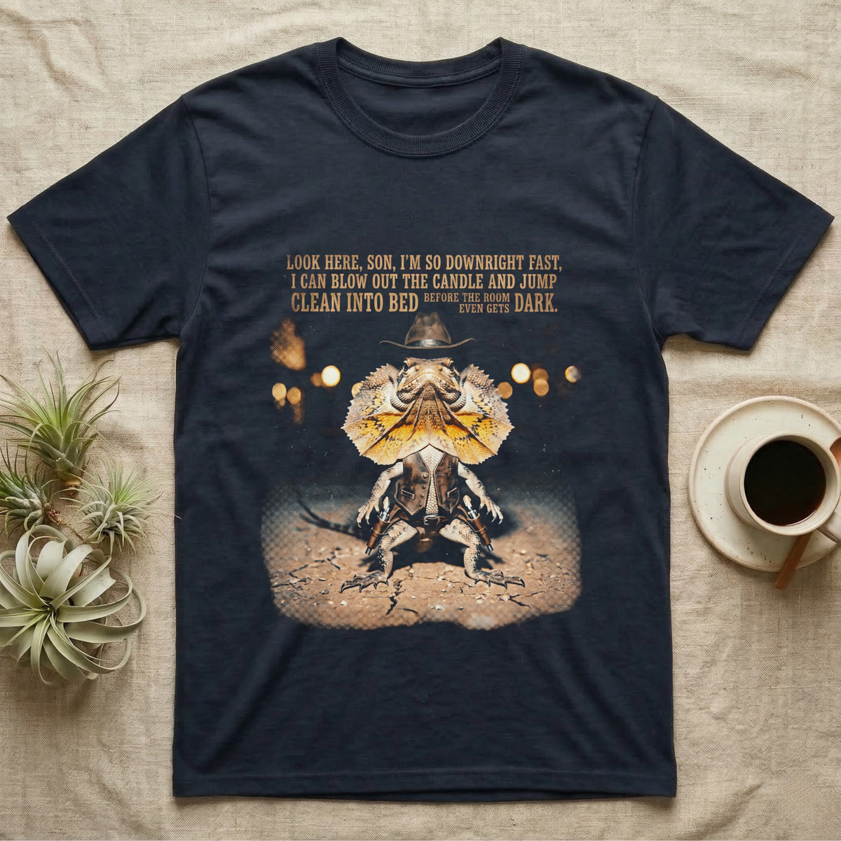 Frilled Lizard Cowboy T-Shirt in Navy — Frilled lizard dressed as a Wild West cowboy with a Stetson and twin holsters under a tall-tale quote in distressed halftone.