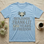Axolotl Benjamin Franklin T-Shirt in Light Blue — Flat cream axolotl as Ben Franklin in glasses above bold text reading Benjamin Frank-Lit, 250 Years of Freedom.