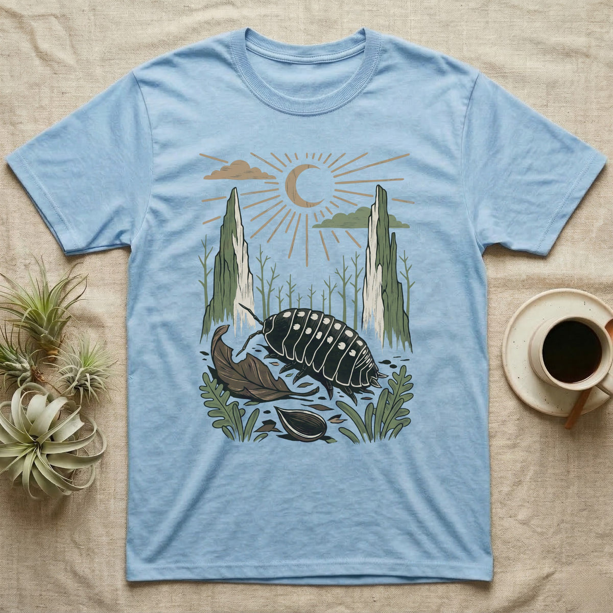 Cubaris Isopod Home Range T-Shirt in Light Blue — Woodcut-style illustration of a Cubaris isopod walking across leaf litter with cypress knees and saplings behind, no on-shirt text.