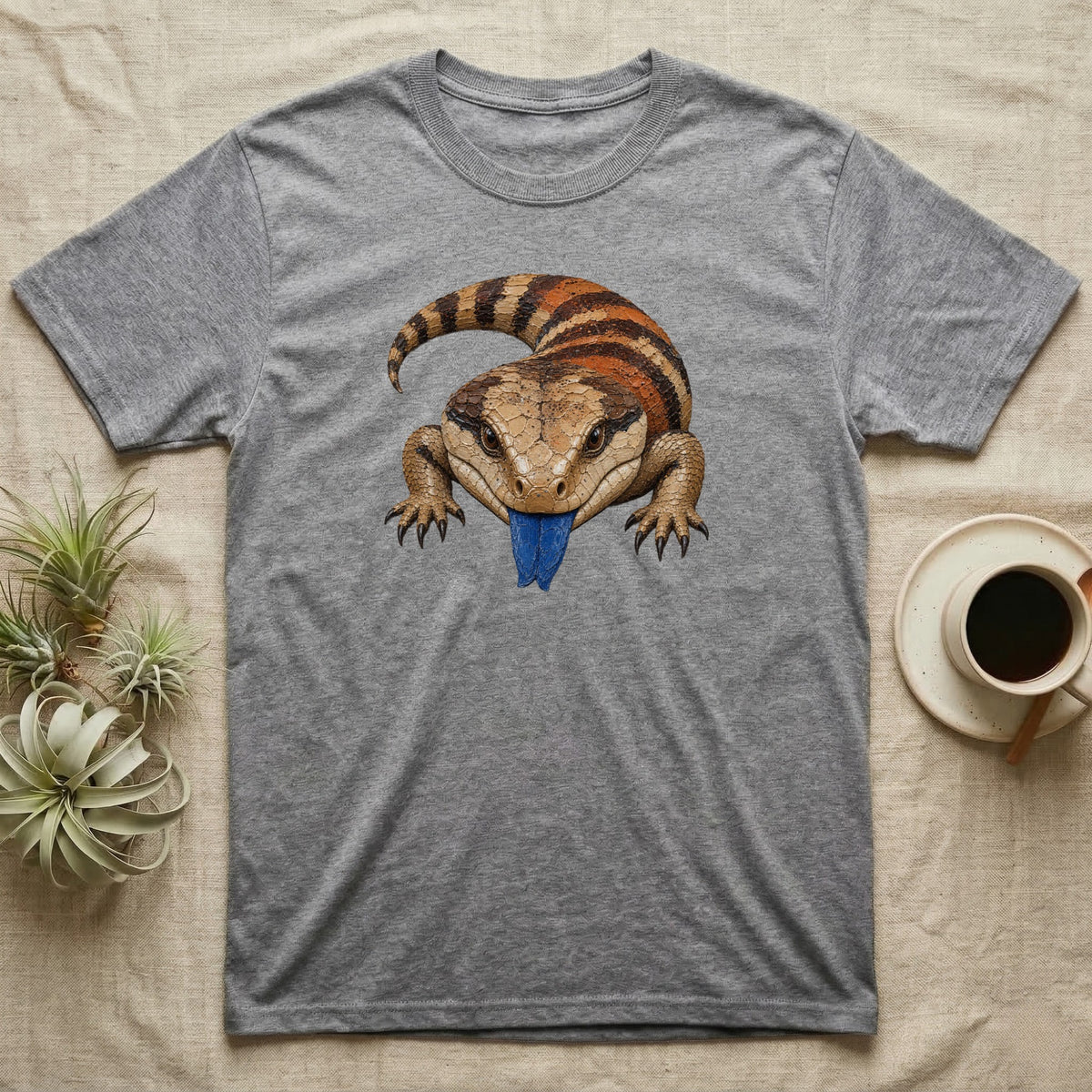 Grey t-shirt featuring a blue-tongued skink with its tongue sticking out.