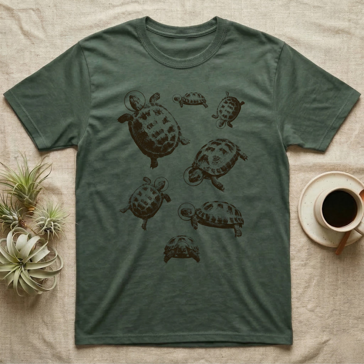 Russian Tortoise Space Helmets T-Shirt in Military Green — One-ink screen print of seven Russian tortoises in rounded space helmets drifting at varied sizes.
