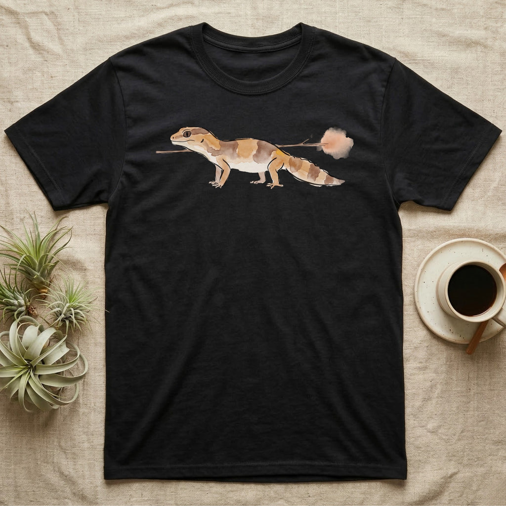 African Fat-Tailed Gecko Watercolour T-Shirt in Black — Watercolour African fat-tailed gecko in profile beneath a thin twig ending in a soft bloom, drawn with a broken ink line.