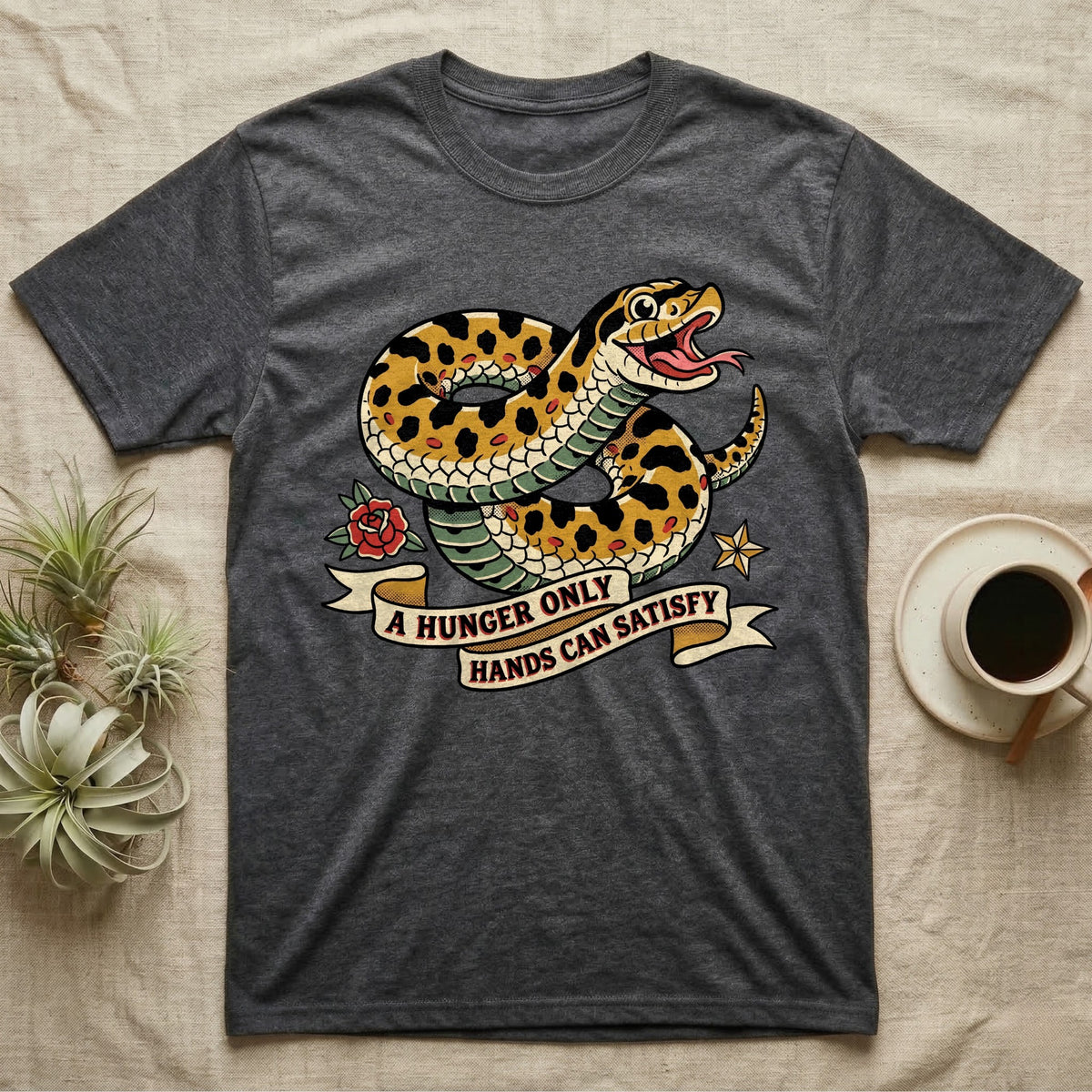 Hognose Hunger Flash T-Shirt in Dark Heather — American-traditional tattoo-flash illustration of a hognose snake in a heroic coil with a banner reading the feeding-hunger line.