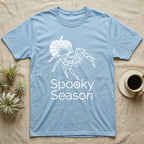 Jumping Spider Spooky Season T-Shirt in Light Blue — Minimal continuous-line jumping spider over a spiderweb pumpkin, text "Spooky Season" with a spider in the O.