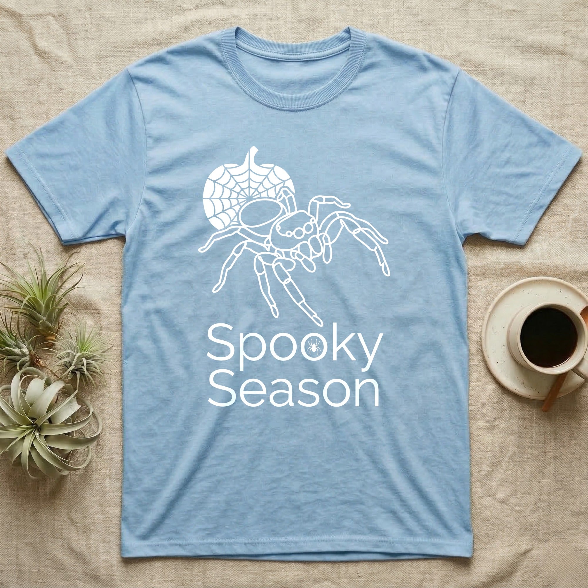 Jumping Spider Spooky Season T-Shirt in Light Blue — Minimal continuous-line jumping spider over a spiderweb pumpkin, text "Spooky Season" with a spider in the O.