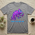 Grey t-shirt with neon purple and blue chameleon and text "NOW YOU SEE ME".