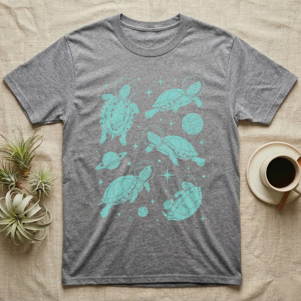 Red Eared Slider Cosmic T-Shirt in Sport Grey — Vintage screen-print illustration of red-eared slider turtles in astronaut helmets floating in space, cosmic teal monochromatic on dark background.
