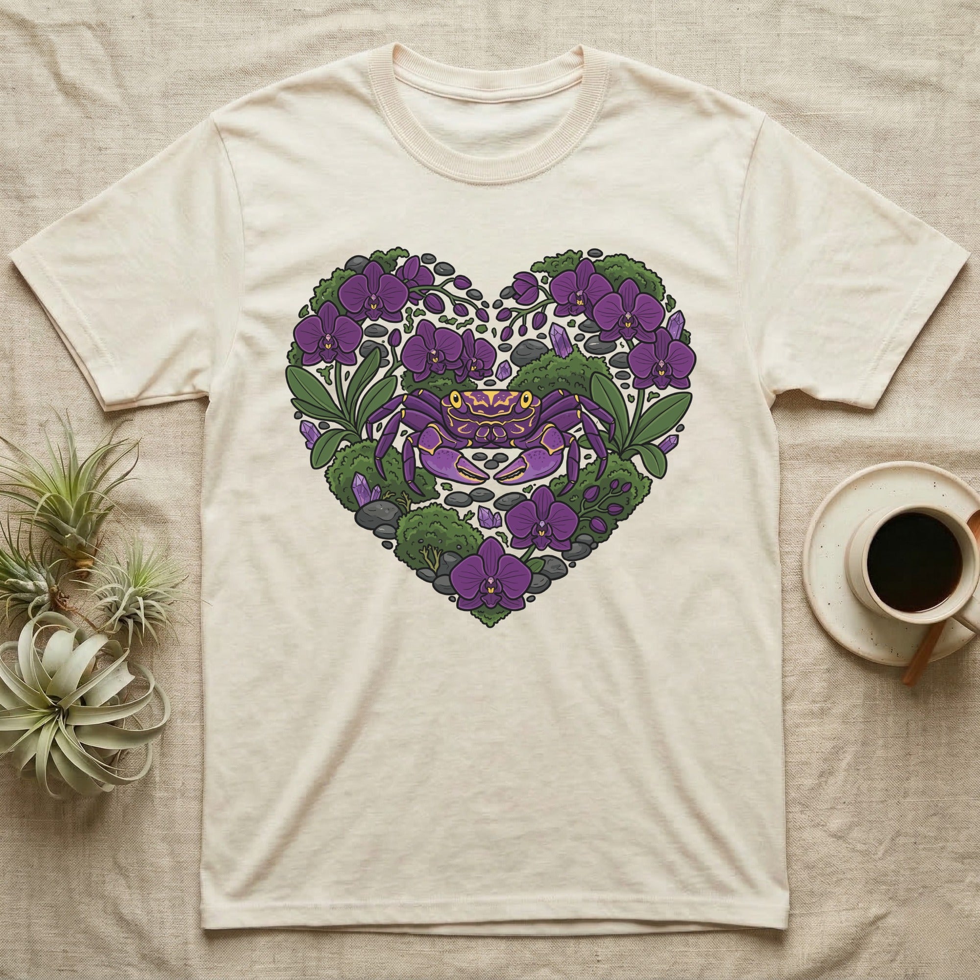 Cream t-shirt with a purple crab and purple flowers in a heart shape.