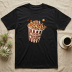Corn Snake Popcorn Bucket T-Shirt in Black — Vintage striped cinema popcorn bucket labelled Fresh Popcorn Snake, overflowing with kernels patterned like corn snake scales.