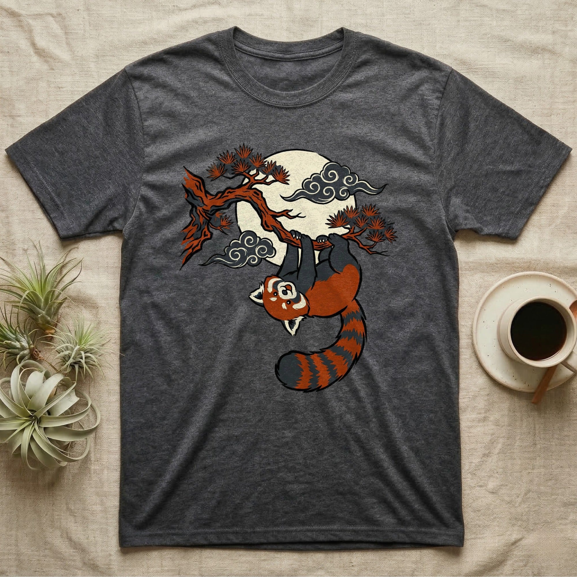 Dark gray t-shirt with red panda hanging from a tree branch against a cloudy moon.