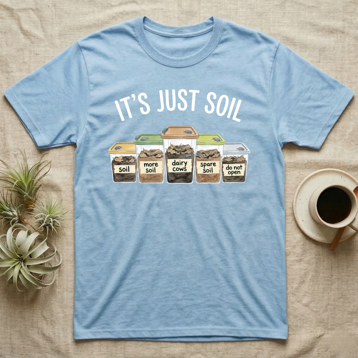 Isopod Soil Bins T-Shirt in Light Blue — Watercolour row of five labelled bins of soil with isopods on the lids under the words IT'S JUST SOIL