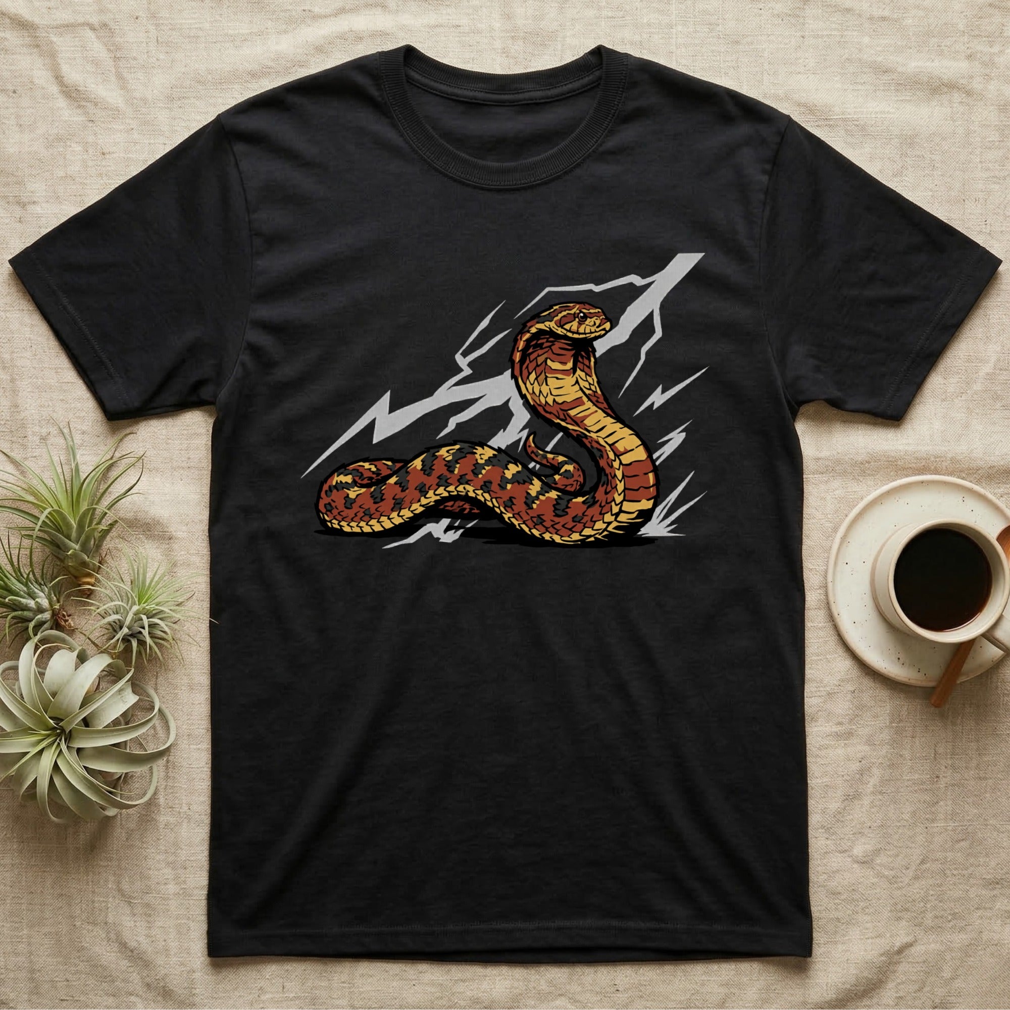 Black t-shirt with a coiled cobra and lightning graphic.