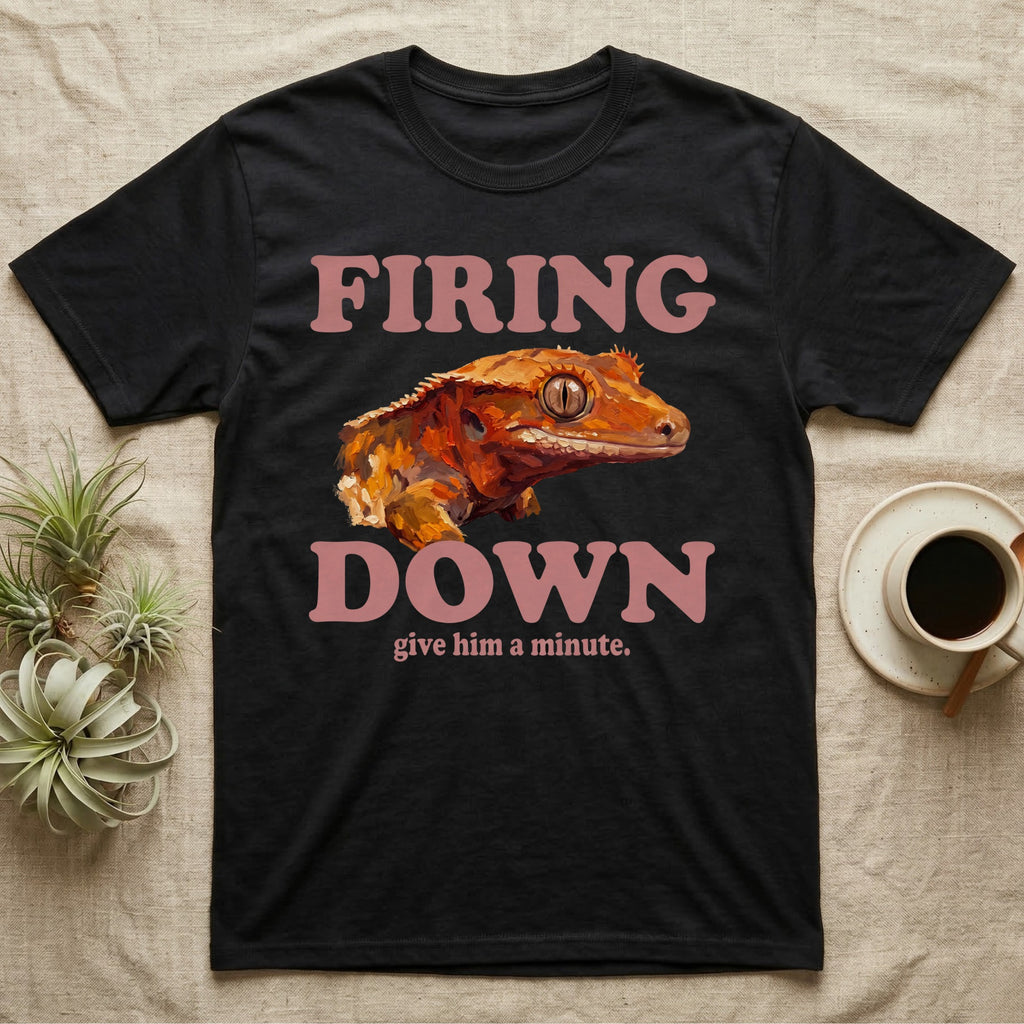 Crested Gecko Firing Down T-Shirt in Black — Engraved crested gecko in navy ink between the rose words Firing and Down, with give him a minute above.