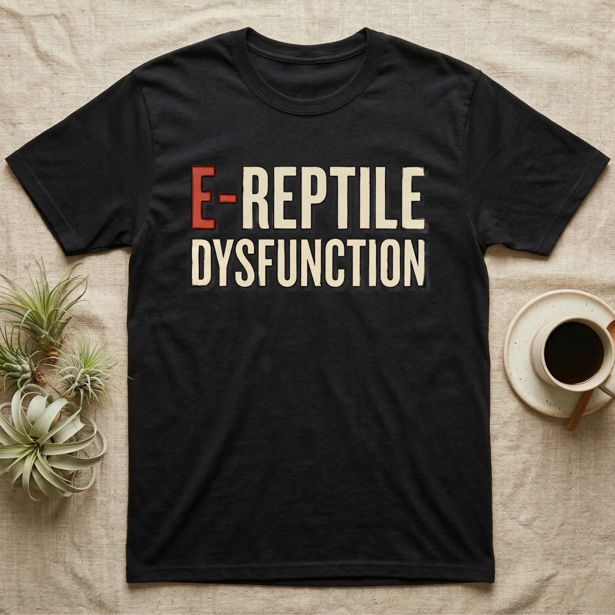 E-Reptile Dysfunction Gecko T-Shirt in Black — Retro-pharmacy typographic wordmark reading "E-Reptile Dysfunction" in distressed cream and tomato-red lettering.