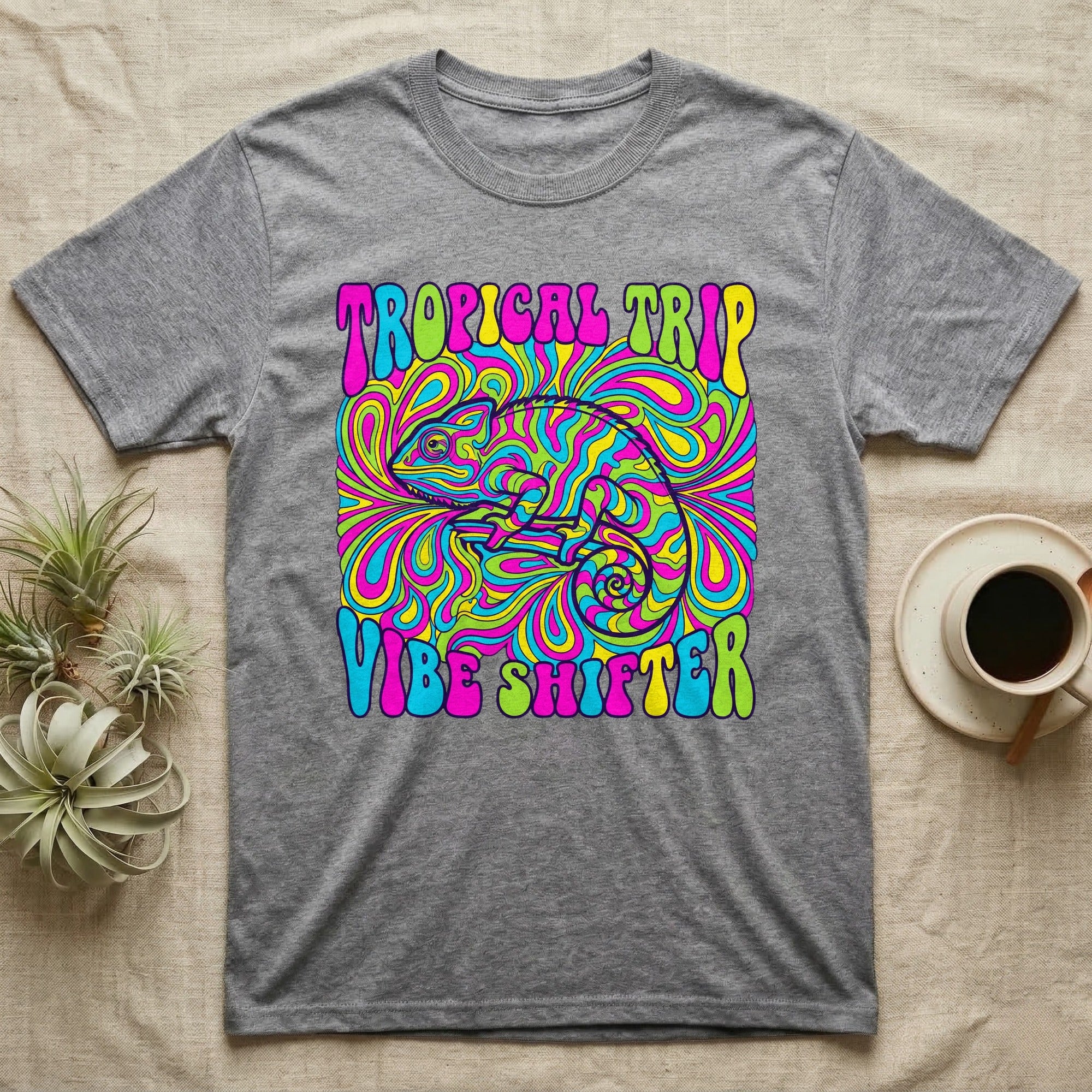 Gray t-shirt with colorful "Tropical Trip Vibe Shifter" text and a psychedelic chameleon.
