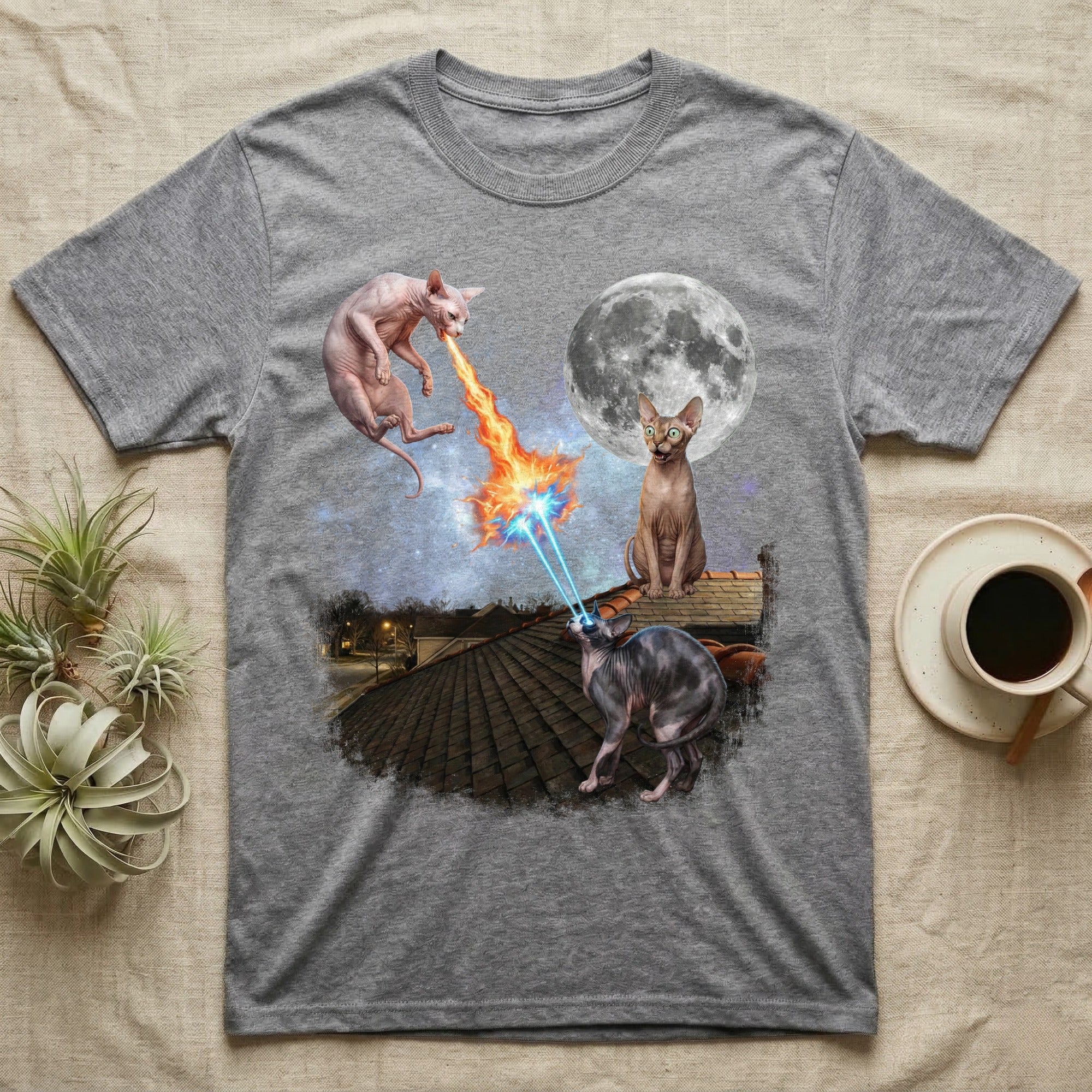 T-shirt with two Sphynx cats shooting lasers over a rooftop at night.