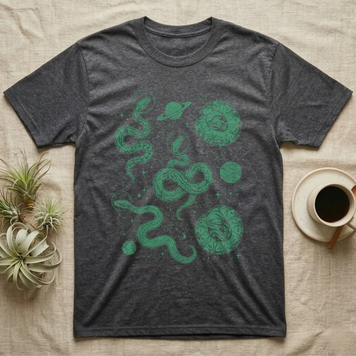 Ball Python Cosmic T-Shirt in Dark Heather — Vintage screen-print illustration of ball pythons in astronaut helmets floating in space, deep emerald green monochromatic on dark background.