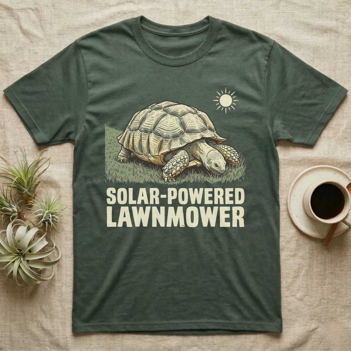 Solar Powered Lawnmower T-Shirt in Military Green — Retro-illustration of a sulcata tortoise grazing a lawn stripe under a sun motif with a Solar-Powered Lawnmower caption.