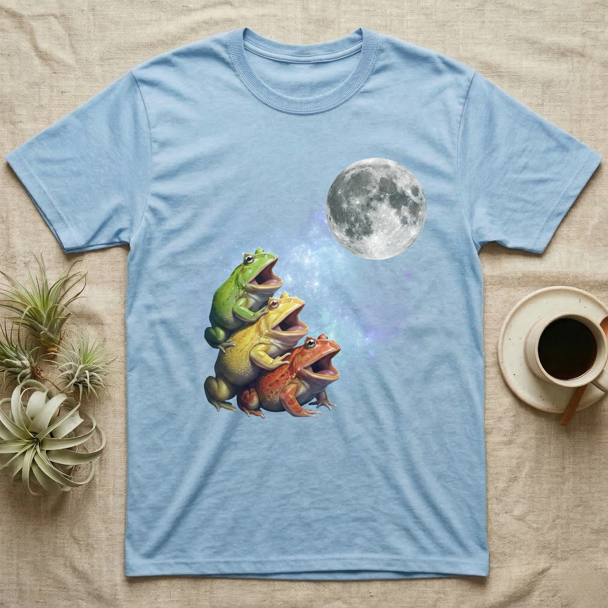 Pacman Frog Moon Howl T-Shirt in Light Blue — Three Pacman Frog colour morphs howling at a full moon over a nebula on a dark grey t-shirt.