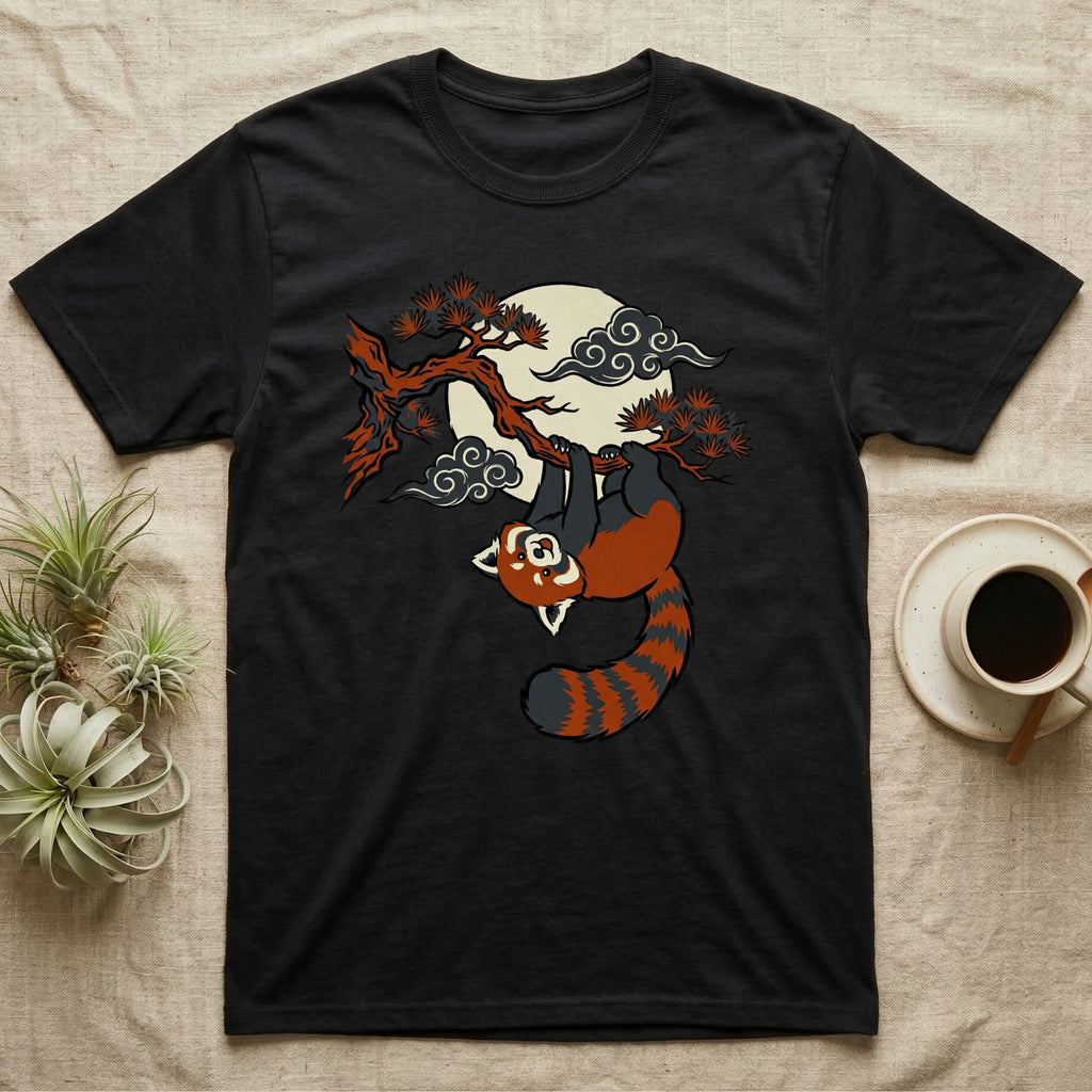 Black t-shirt with a red panda hanging from a tree branch under a cloudy moon.