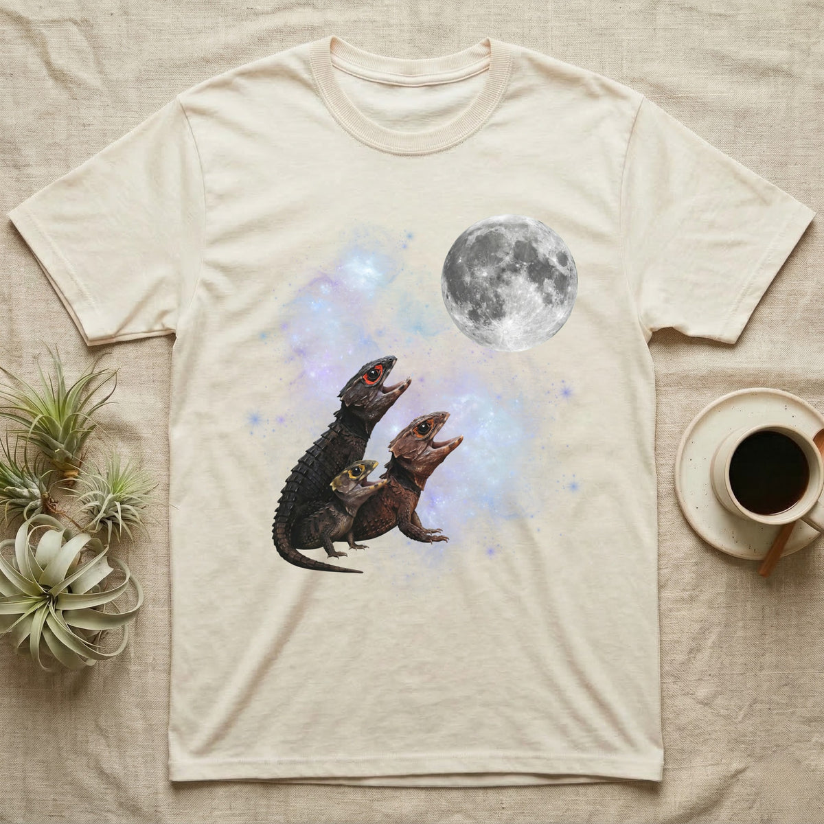 Red-Eyed Crocodile Skink Moon Howl T-Shirt in Natural — Three Red-Eyed Crocodile Skink colour morphs howling at a full moon over a nebula on a dark grey t-shirt.