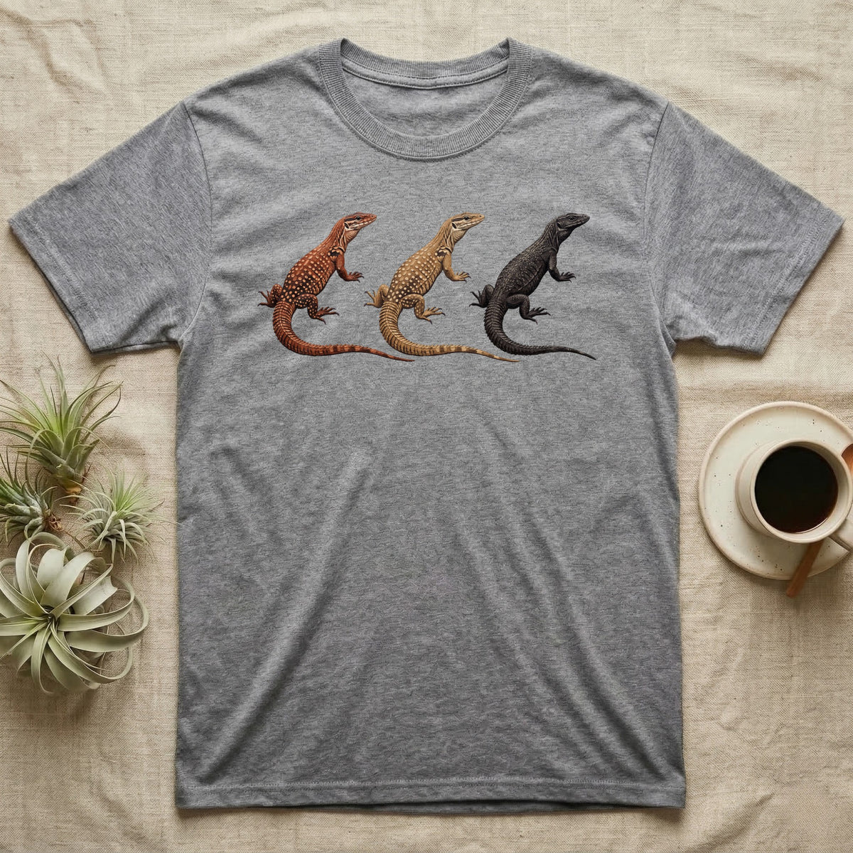 Ackie Monitor Triptych T-Shirt in Sport Grey — Three ackie monitors in a row, painted in thick impasto — red, yellow and dark island forms with pale ocelli.