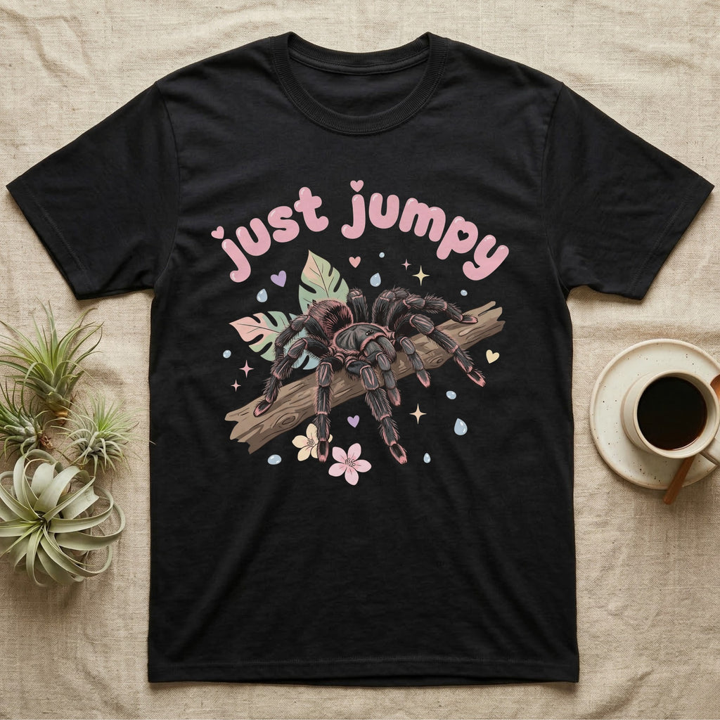 Pink Toe Tarantula Softie T-Shirt in Black — Pink toe tarantula poised to leap on a branch under a puffy pastel "just jumpy" bubble wordmark with tiny hearts.