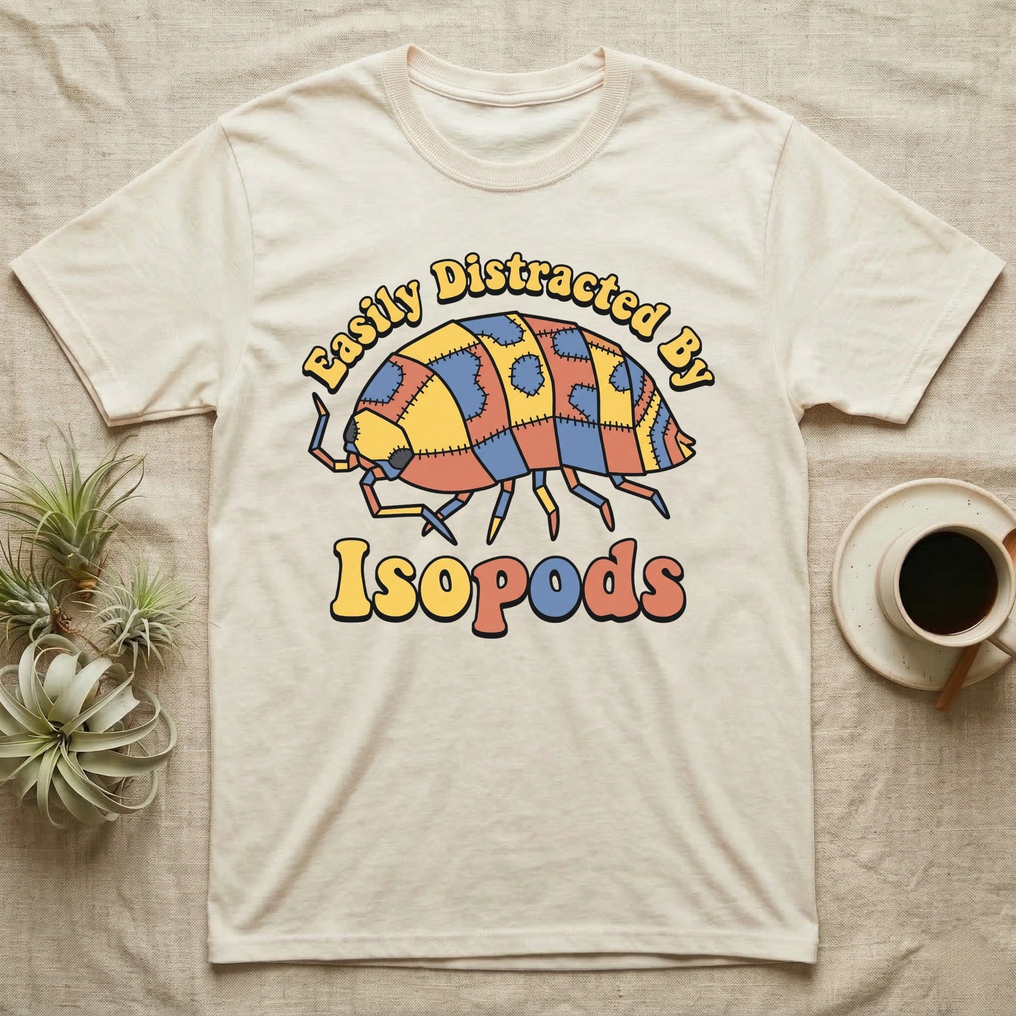 Dairy Cow Isopod Patchwork T-Shirt in Natural — Quilt-patchwork dairy cow isopod in mustard and denim under retro "Easily Distracted By Isopods" text.