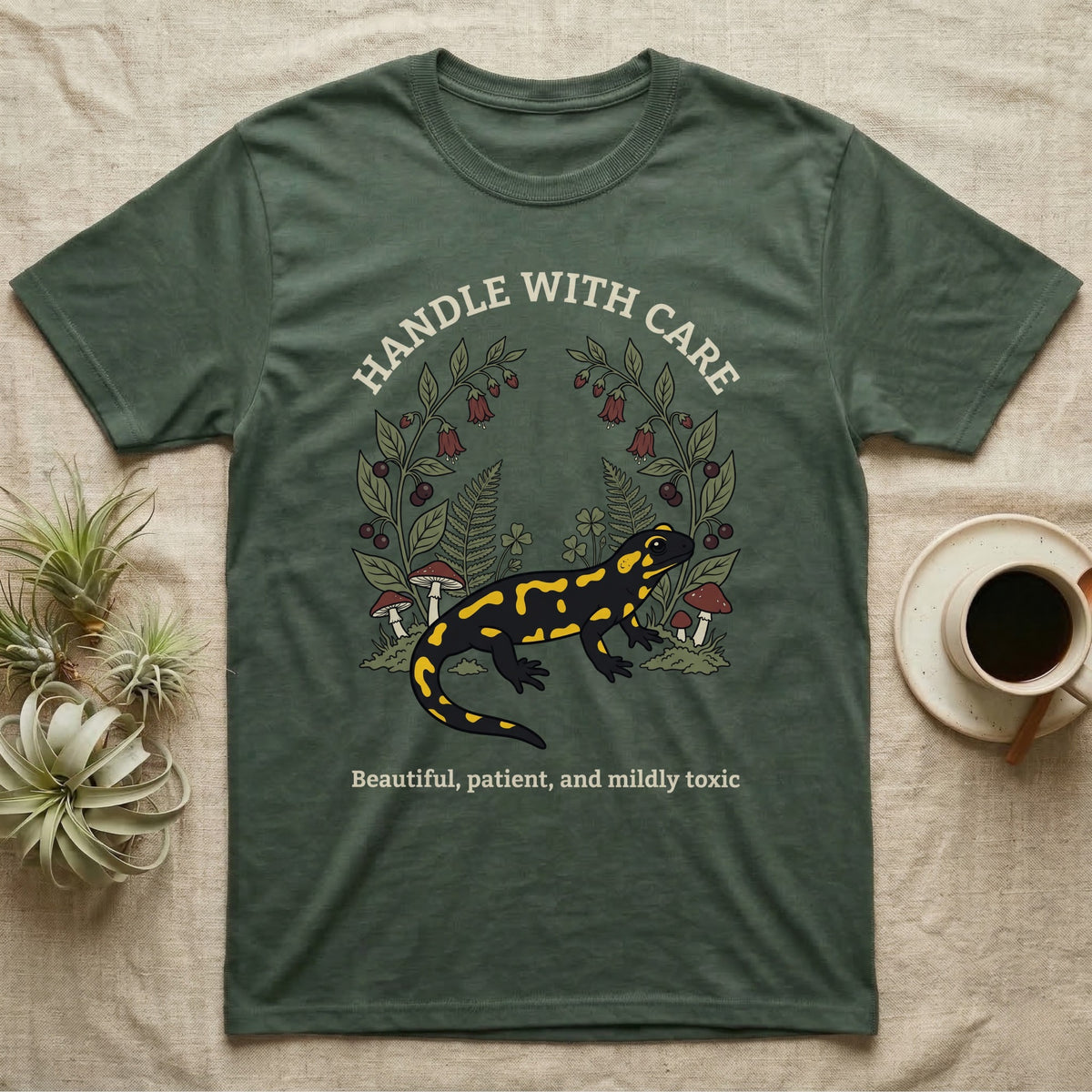 Fire Salamander Poison Plate T-Shirt in Military Green — Naturalist apothecary-plate illustration of a fire salamander framed by a symmetric wreath of woodland botanicals.