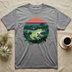 Glass Frog See-Through T-Shirt in Sport Grey — Flat-colour circle-window illustration of a glass frog silhouetted crossing a rainforest canopy scene.