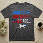 Gecko Four Score T-Shirt in Dark Heather — Block text Four Score and Seven Tails Ago with a flag-filled word above a white gecko silhouette shedding its tail.