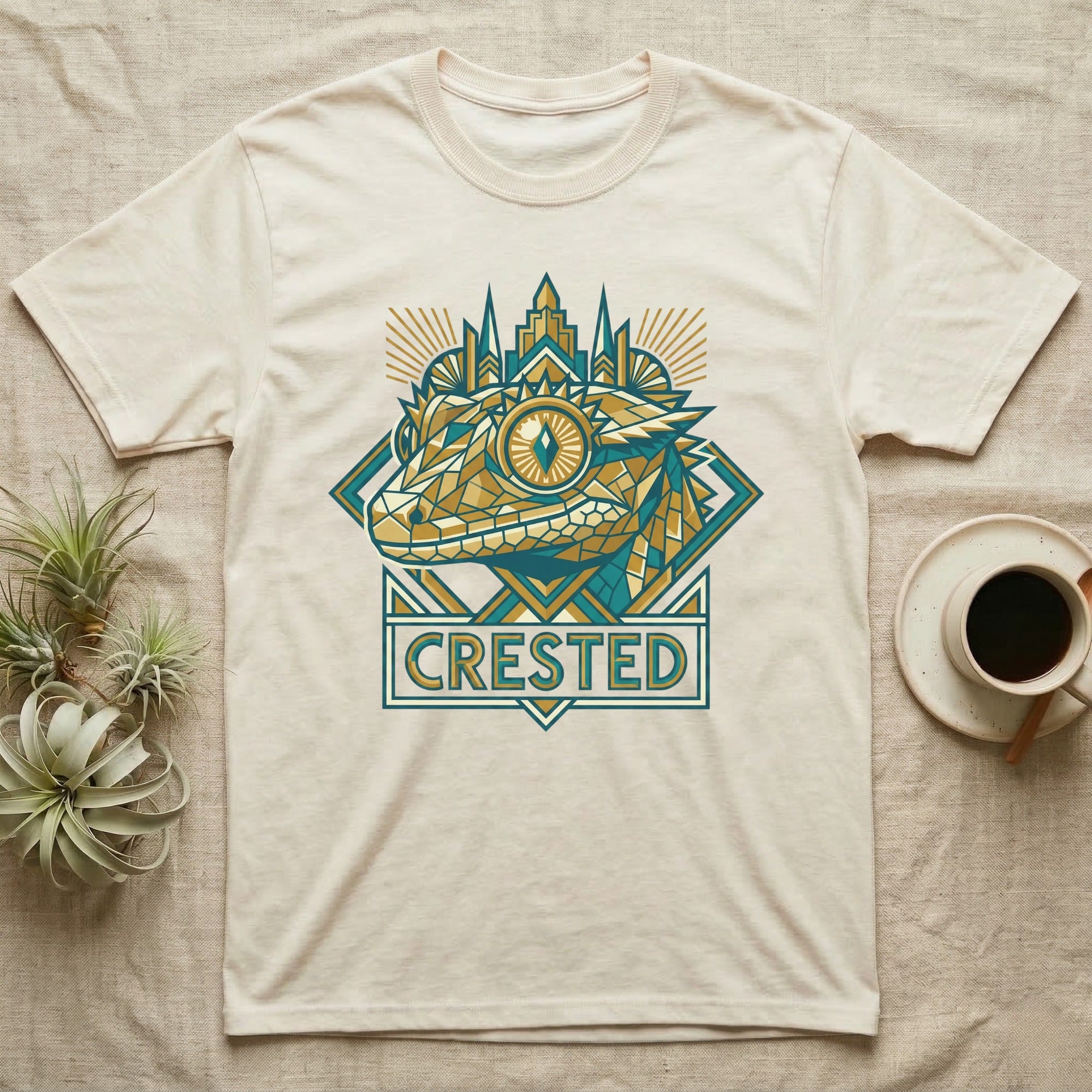 Cream t-shirt with geometric gecko design and "CRESTED" text.
