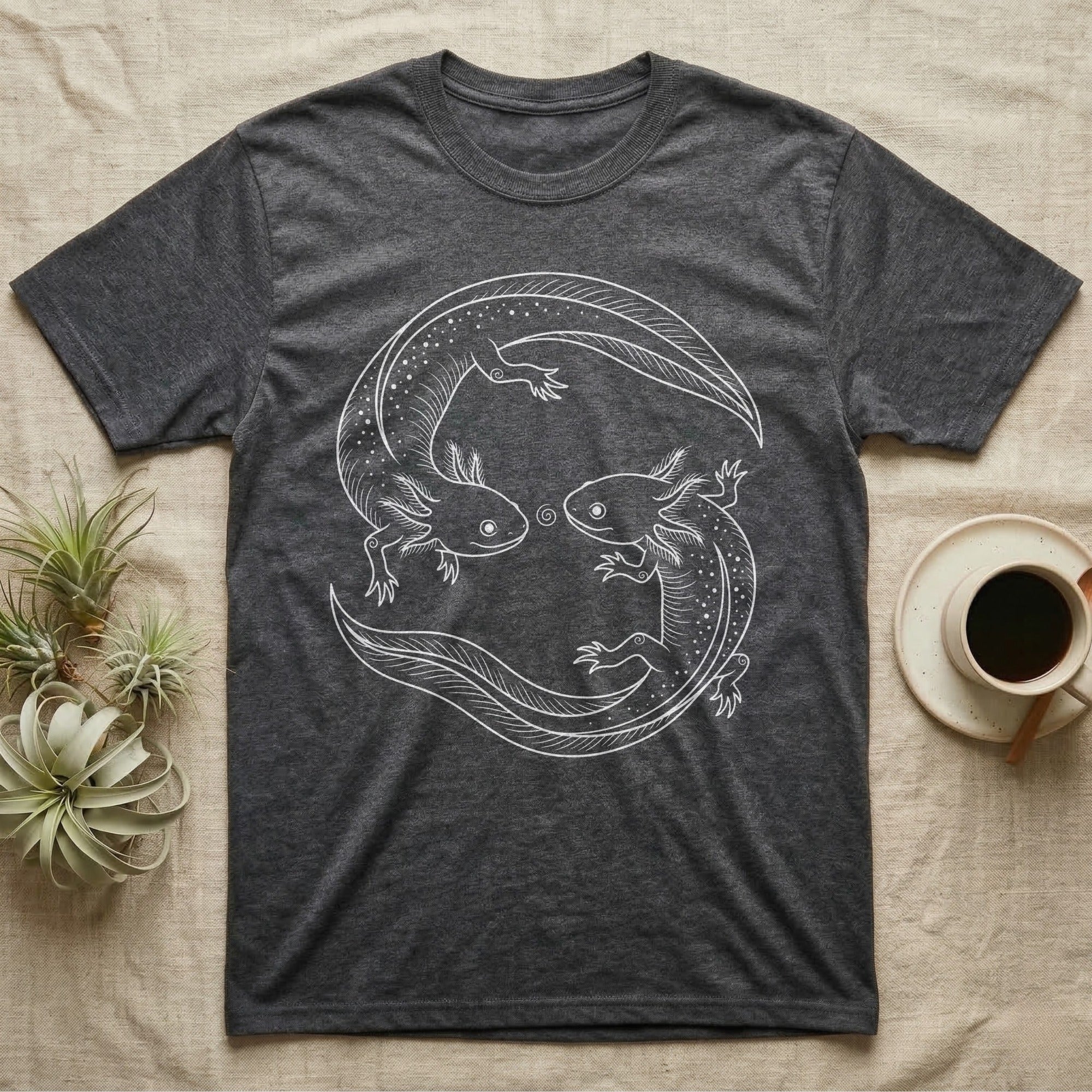 Axolotl Pair Roundel T-Shirt in Dark Heather — Fine-line drawing of two axolotls in a rotational roundel, heads meeting over a small spiral on grey