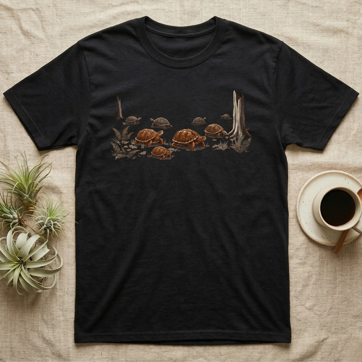 Box Turtle Forest Floor T-Shirt in Black — Sepia ink and wash illustration of eight eastern box turtles crossing open woodland between two deadfall trunks.