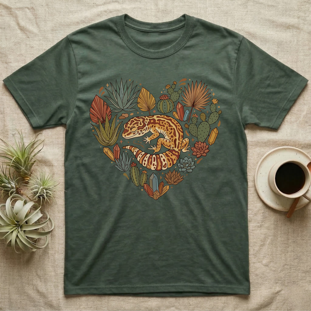 Green t-shirt with a heart-shaped design of a gecko and desert plants.
