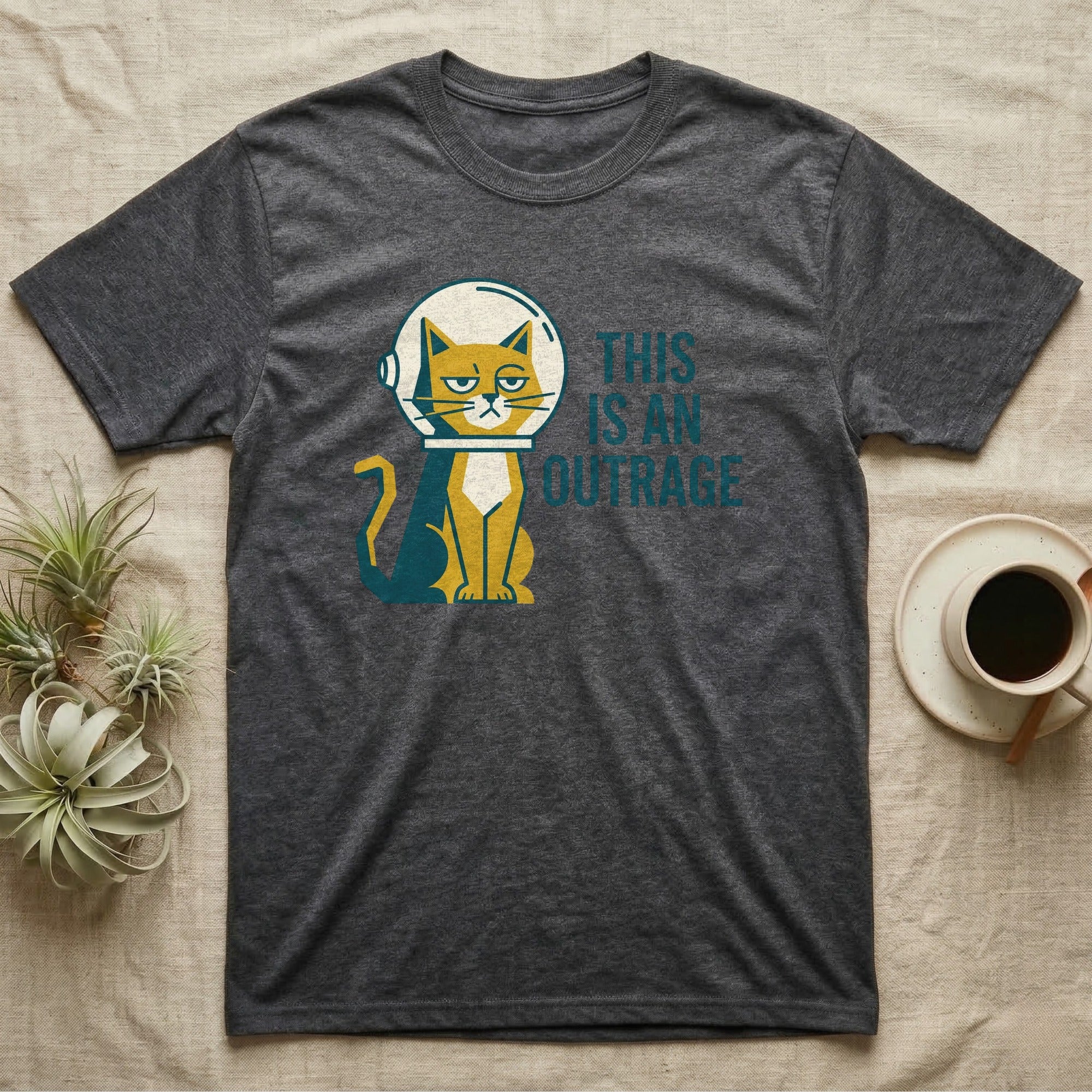 Dark gray t-shirt with a cartoon cat in an astronaut helmet saying "THIS IS AN OUTRAGE".