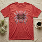 Red t-shirt with a colorful tarantula graphic on chest, coffee cup nearby.