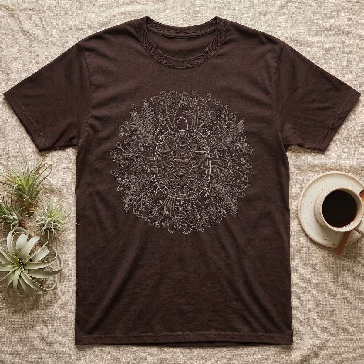 Box Turtle Wreath T-Shirt in Dark Chocolate — Cream line art of a box turtle seen from above, its shell ringed like a tree stump, in a wreath of ferns and toadstools.