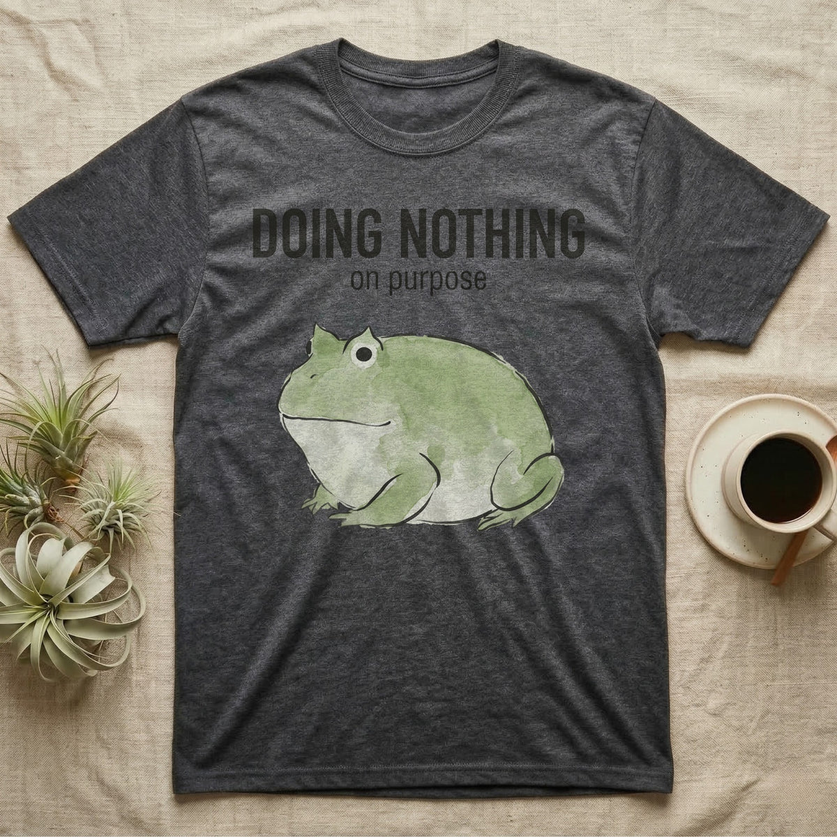 Pacman Frog Doing Nothing T-Shirt in Dark Heather — Watercolour pacman frog blob in profile below the words doing nothing on purpose, on grey