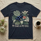 Plants And Frogs T-Shirt in Navy — Naturalist-plate illustration of a dart frog perched in lush foliage with hand-lettered text reading My Plants And My Frogs.