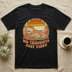 Black t-shirt with retro design of a lizard and "NO THOUGHTS JUST VIBES" text.