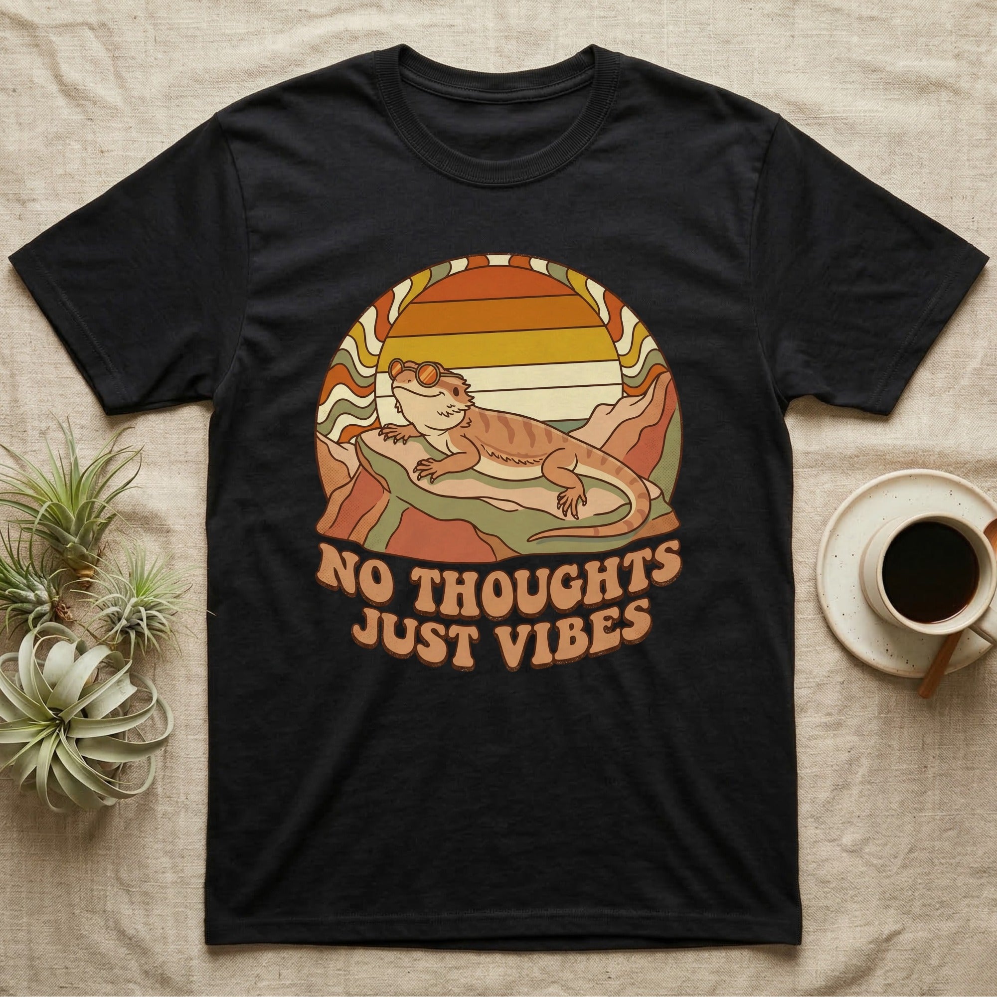 Black t-shirt with retro design of a lizard and "NO THOUGHTS JUST VIBES" text.