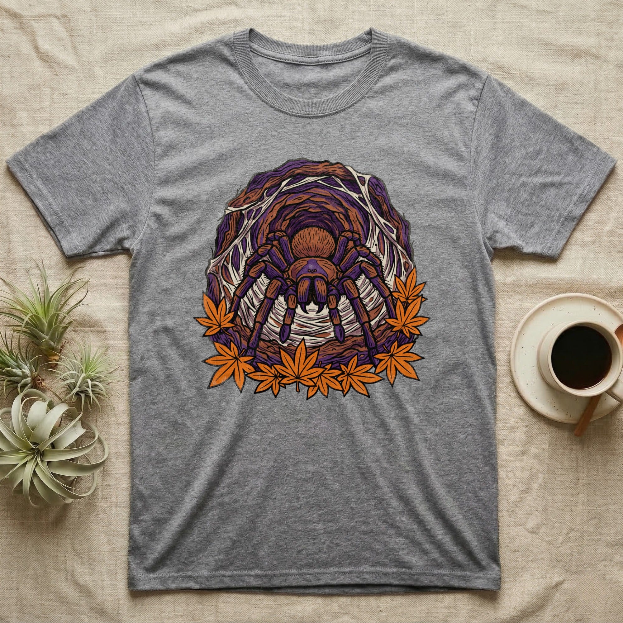 Grey t-shirt with tarantula and autumn leaves graphic.
