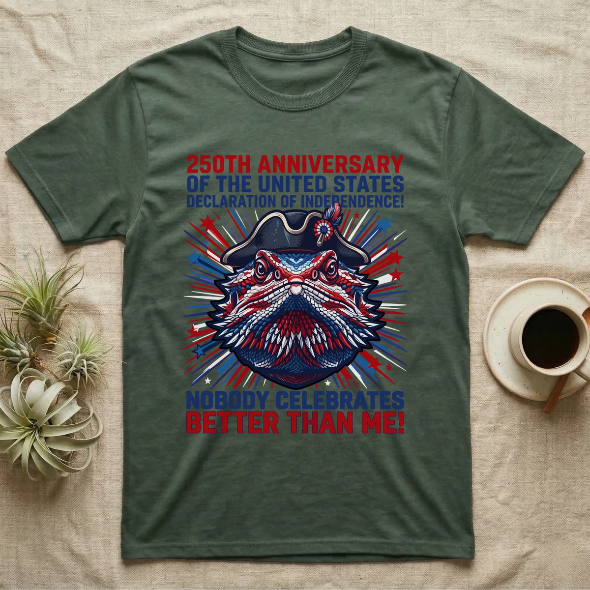 Bearded Dragon Fireworks T-Shirt in Military Green — Pop-art bearded dragon head in a tricorn hat amid red-white-blue fireworks under Nobody Celebrates Better Than Me.