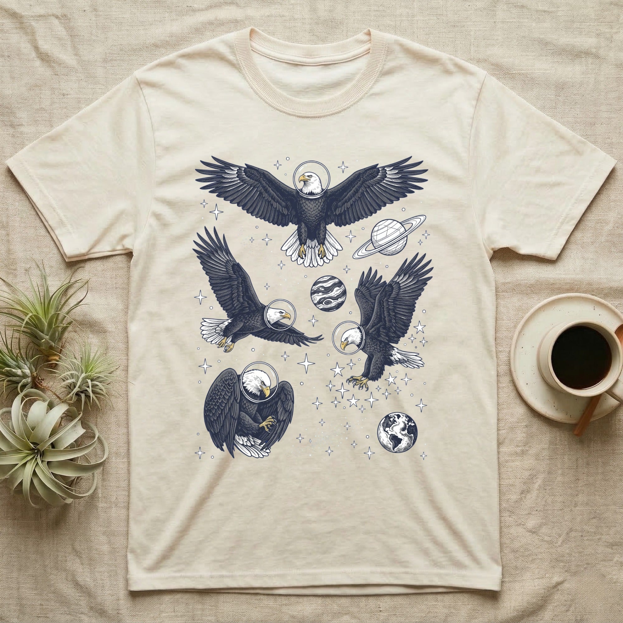 Cream t-shirt with four detailed eagle illustrations and celestial elements.
