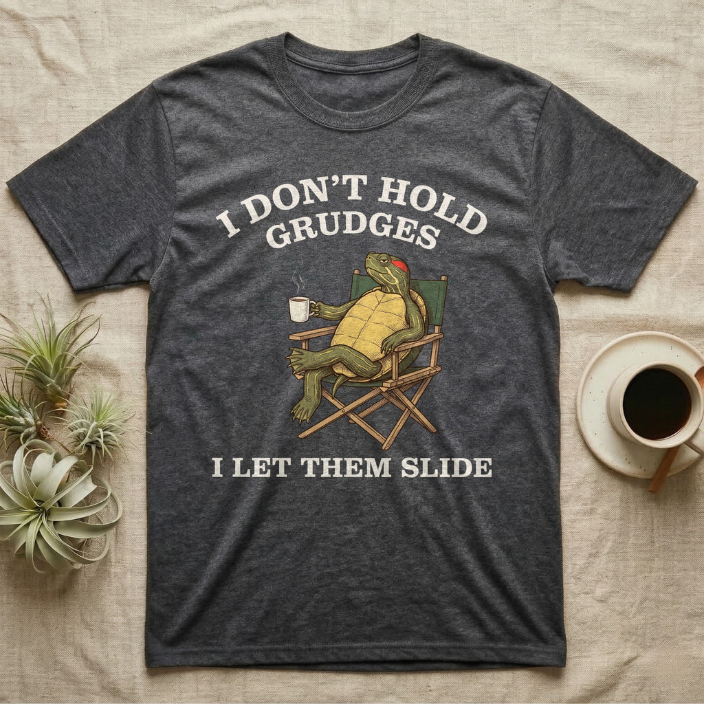 Red-Eared Slider Grudges T-Shirt in Dark Heather — Engraved red-eared slider lounging in a camp chair with tea under I Don't Hold Grudges I Let Them Slide