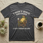 Red-Eared Slider Grudges T-Shirt in Dark Heather — Engraved red-eared slider lounging in a camp chair with tea under I Don't Hold Grudges I Let Them Slide